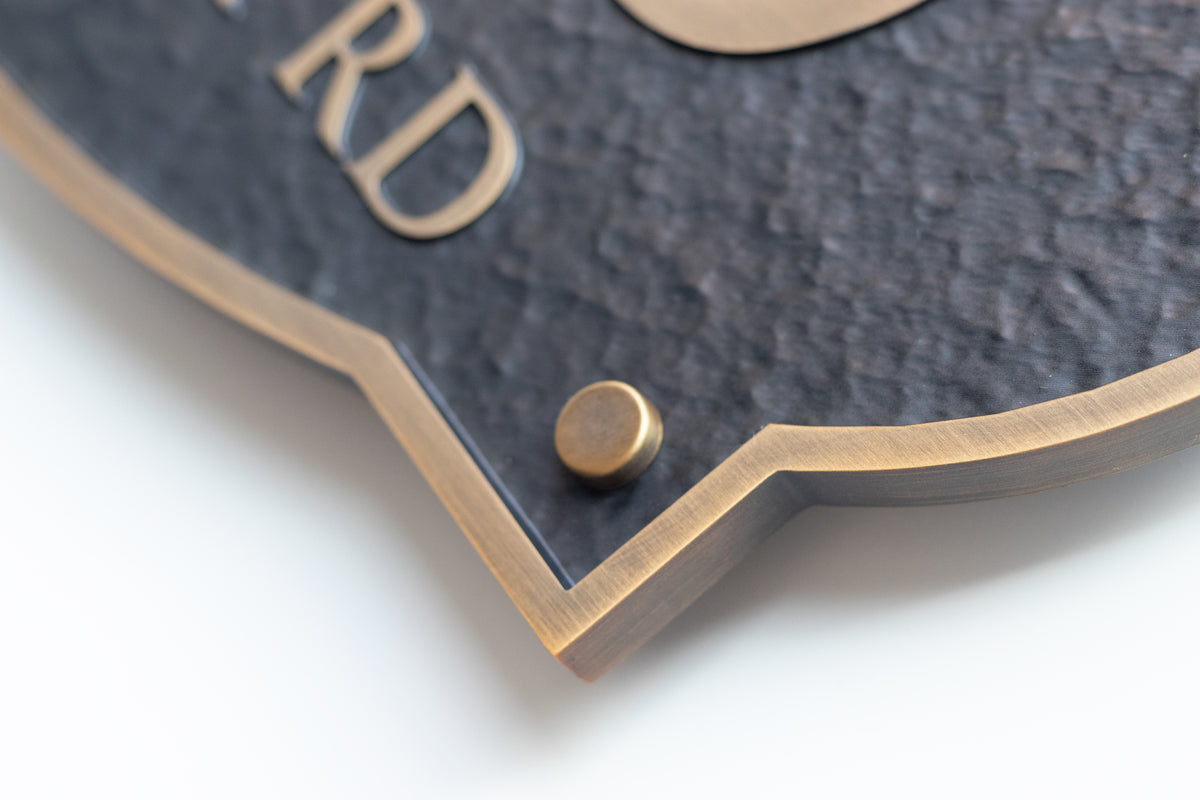 Detailed view of textured black finish, brass border and decorative mounting cap