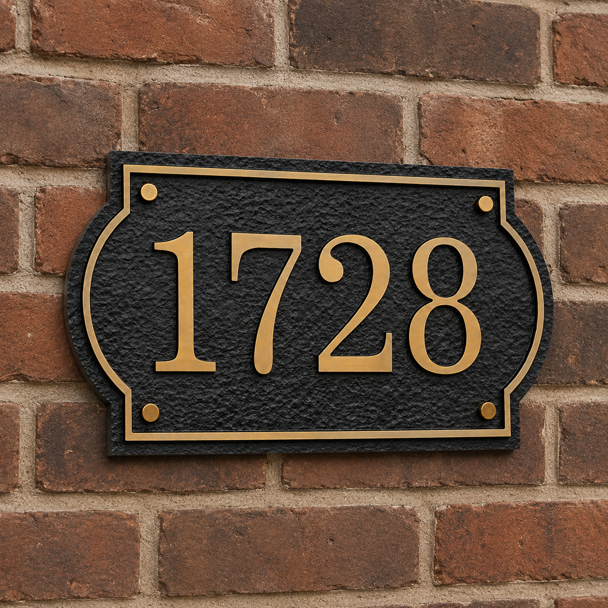 Rustic house number plaque mounted on a red brick exterior wall