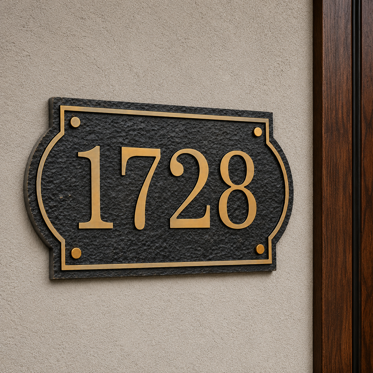 Solid aluminum house number sign installed beside a wooden front door