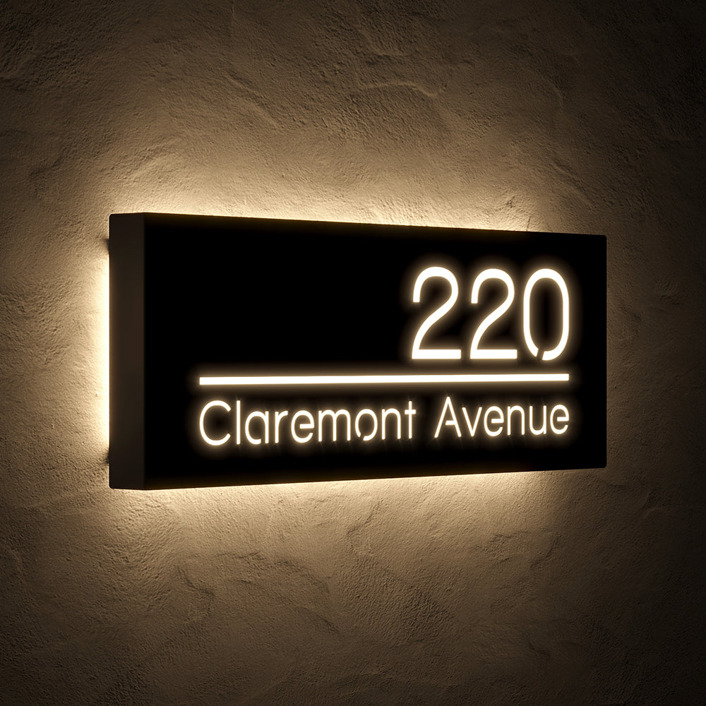 Line Design LED Address Sign with Street Name with 220 Claremont Avenue shown at an angle in warm white backlighting
