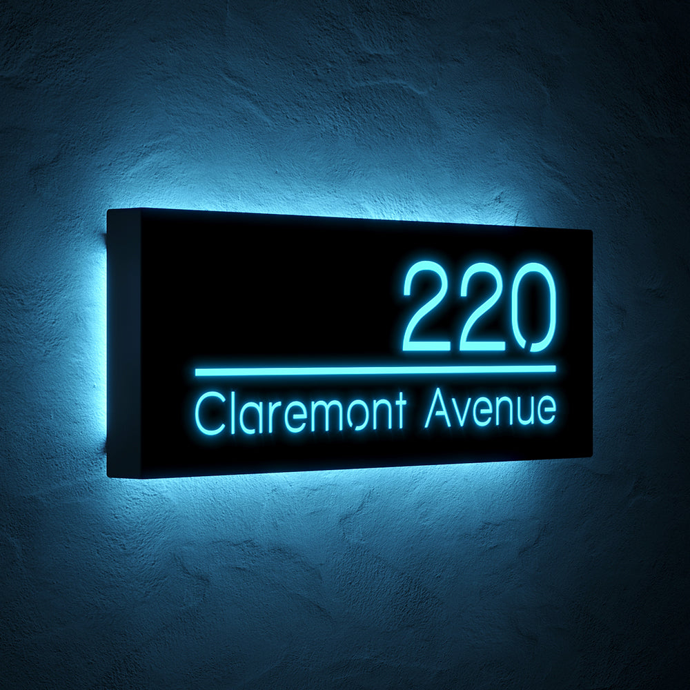 Line design LED address sign with 220 Claremont Avenue in blue light