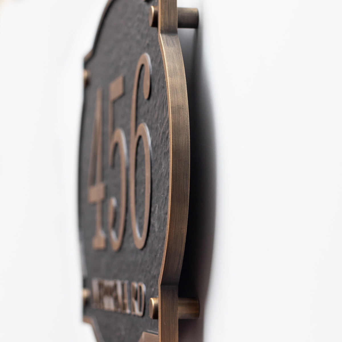 Side profile showing 10mm aluminum plaque thickness and raised wall installation