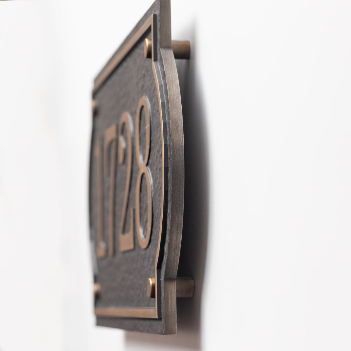 Side view of 10mm solid aluminum address plaque with floating wall mounts