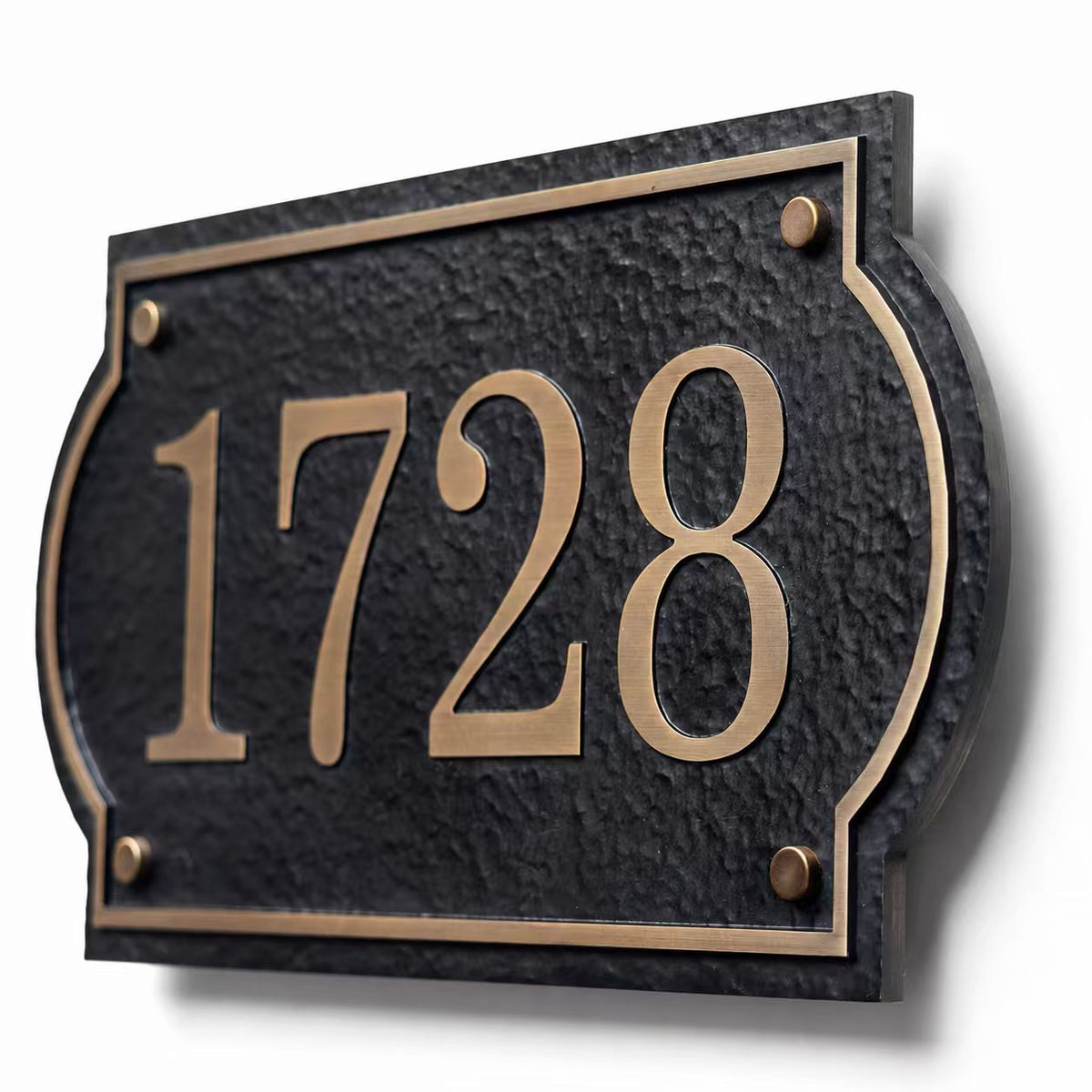 Custom solid aluminum house number plaque with antique brass finish on white background
